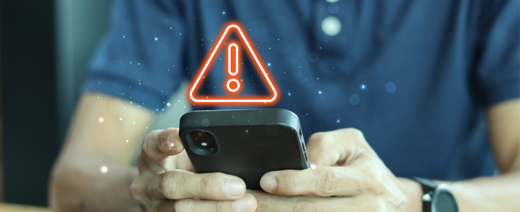 Man holding phone with an exclamation warning above.